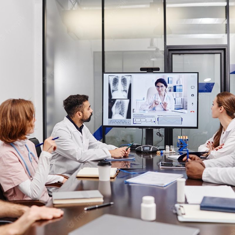 large-group-intercultural-medical-workers-looking-their-colleague-computer-screen-while-watching-online-presentation_236854-37406